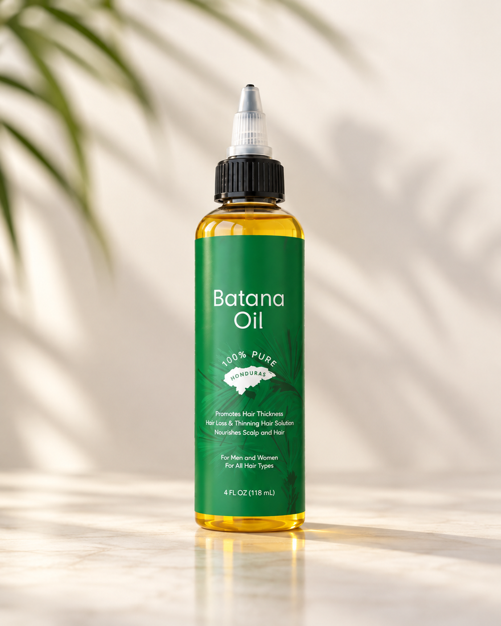 Hand holding a bottle of My Batana Oil, 100% pure Batana oil from Honduras for curly and coily hair
